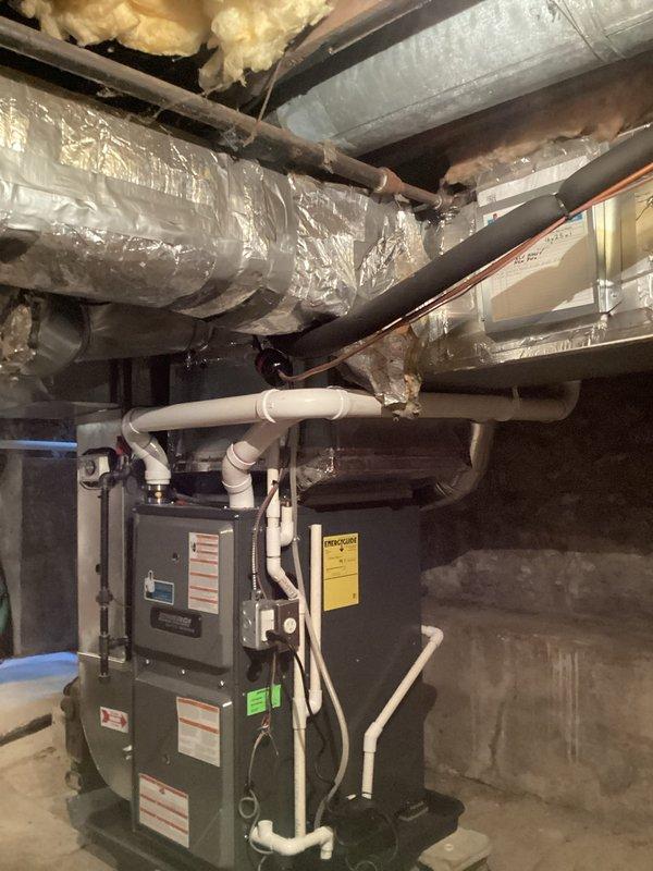 Completed installation of AprilAire whole-home humidifier with manual control in basement mechanical room. Unit was mounted to existing HVAC ductwork system and connected to metallic supply ducts, with all electrical connections terminated and water supply line plumbed to humidifier. System tested and verified operational upon completion.