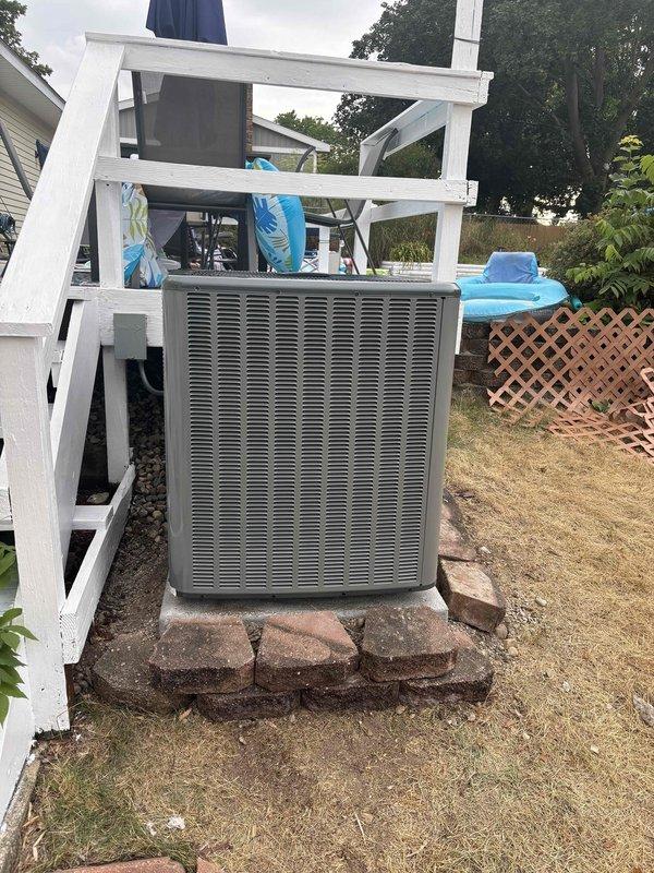 Successfully completed full air conditioning system replacement at residential property. Removed existing outdoor condenser unit and installed new unit on brick paver pad in backyard area adjacent to rear deck and patio entrance. New condenser positioned on prepared base with proper clearances maintained from structure and surrounding elements. Unit installed with appropriate refrigerant line connections, electrical hookup, and drainage provisions. System startup performed, operational parameters verified, and unit tested for proper cooling cycle operation.