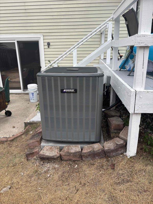 Successfully completed full air conditioning system replacement at residential property. Removed existing outdoor condenser unit and installed new unit on brick paver pad in backyard area adjacent to rear deck and patio entrance. New condenser positioned on prepared base with proper clearances maintained from structure and surrounding elements. Unit installed with appropriate refrigerant line connections, electrical hookup, and drainage provisions. System startup performed, operational parameters verified, and unit tested for proper cooling cycle operation.