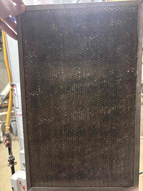 # NC-No Cool Service Completed

Responded to no cooling call with furnace blower and outdoor unit not operating. Upon arrival, performed system inspection and identified severely restricted airflow due to heavily contaminated air filter with excessive dust and debris accumulation. Filter showed extended period of use without replacement, blocking proper air circulation through the system.

Inspected outdoor condensing unit and found significant dirt and debris buildup on condenser coil fins and louvers, restricting heat transfer capability and airflow. The contamination was concentrated on the intake sections, preventing adequate ventilation required for proper system operation.

Replaced clogged air filter with new filter to restore proper airflow through the system. Cleaned outdoor condenser coil and louvers to remove accumulated dirt and debris, restoring heat rejection capacity. Verified both indoor blower and outdoor unit returned to normal operation with adequate airflow. System 