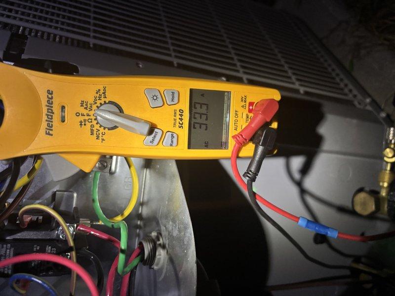 # CP-Cooling Problem Resolution

Responded to service call for air conditioning unit experiencing intermittent operation - system would run and produce cold air before shutting down unexpectedly. Upon arrival, performed comprehensive electrical diagnostics using digital multimeter to identify the root cause of the premature shutdown.

Conducted amperage measurements on the compressor circuit, which revealed a reading of 22.2 amps during operation. Further electrical testing indicated abnormal readings displayed as "E.E.E" on the meter, suggesting an electrical fault condition within the system. Inspected all wire connections, including multi-phase power wiring (green, red, blue, and black conductors) connected to the compressor motor assembly. Verified integrity of capacitor and associated electrical components within the control circuit.

Diagnosed issue as electrical fault causing safety shutdown of the system. Addressed the problem by correcting the electrical anomaly, ensuring all 