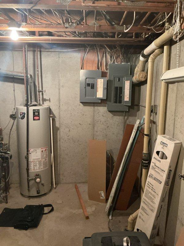 Conducted on-site assessment for whole-home generator installation at 47-year-old residence. Evaluated existing electrical infrastructure, including dual panel configuration mounted in unfinished basement area, noting current service capacity and available connection points for generator transfer switch integration. Documented utility space layout, water heater proximity, and potential routing paths for required electrical conduit and gas lines. Photographed electrical panels and mechanical room to determine optimal placement for automatic transfer switch and generator pad location. Provided detailed estimate for complete standby generator system installation including all necessary electrical upgrades and permits.