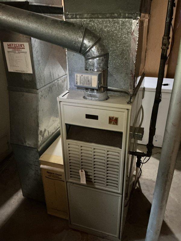 Responded to service call for non-operational outdoor fan on 15-year-old air conditioning system. Upon arrival, inspected Carrier furnace unit (Model S94GAW036100) and associated HVAC equipment in basement mechanical room. Diagnosed fan motor failure, performed necessary repairs to restore cooling system operation, and verified proper airflow through ductwork and plenum assembly.