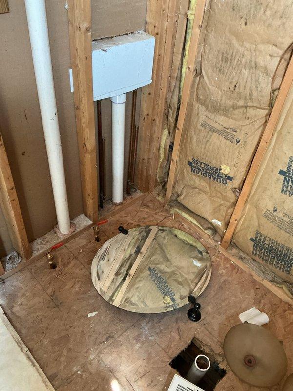 Conducted on-site assessment for rough plumbing installation of new shower in a 20-year-old single-family residence. Evaluated existing framing, insulation, and subfloor conditions in the designated bathroom area where white PVC supply lines and drainage connections are being roughed in through wall studs and floor penetrations. Documented the installation progress with photos showing proper pipe placement, mounting brackets, and preparation for future fixture connections, with all rough plumbing work positioned for code-compliant shower installation once framing inspection is complete.