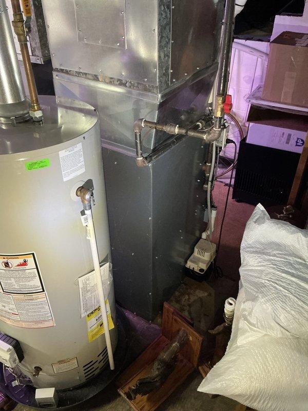 Completed estimate for air conditioning system addition to existing HVAC setup in residential basement mechanical room. Assessed current furnace installation with dual PVC vent pipes and evaluated available space for AC unit integration. Documented existing equipment configuration including water heater placement, ductwork layout, and utility connections to determine optimal positioning for new air conditioning components and necessary modifications to accommodate system expansion.