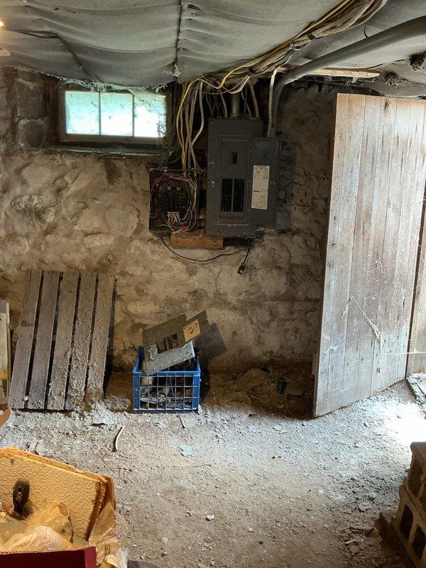 Conducted on-site assessment for mini split system installation in residential property. Evaluated existing electrical infrastructure, including outdated fuse box and modern circuit breaker panel in unfinished basement with stone foundation walls. Inspected exterior electrical meter and service entrance, noting corroded copper conduit and weathered components requiring potential upgrade to support additional HVAC load. Documented current electrical capacity and provided comprehensive estimate for mini split installation with necessary electrical service improvements.