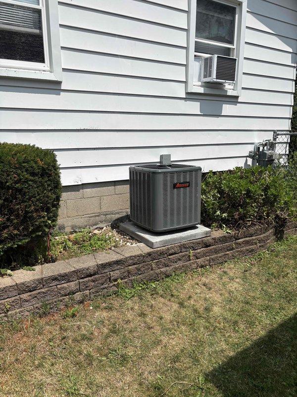 Completed full air conditioning system replacement at residential property. Removed existing condensing unit and installed new Amana brand outdoor condensing unit on existing concrete pad with proper refrigerant line connections and service valves. All refrigerant lines properly insulated and secured, factory and field refrigerant charges recorded on unit specification plate, service valves installed with protective caps, and system tested for proper operation upon completion.