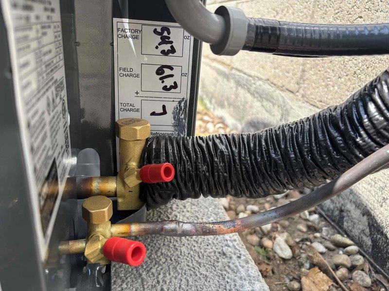 Completed full air conditioning system replacement at residential property. Removed existing condensing unit and installed new Amana brand outdoor condensing unit on existing concrete pad with proper refrigerant line connections and service valves. All refrigerant lines properly insulated and secured, factory and field refrigerant charges recorded on unit specification plate, service valves installed with protective caps, and system tested for proper operation upon completion.