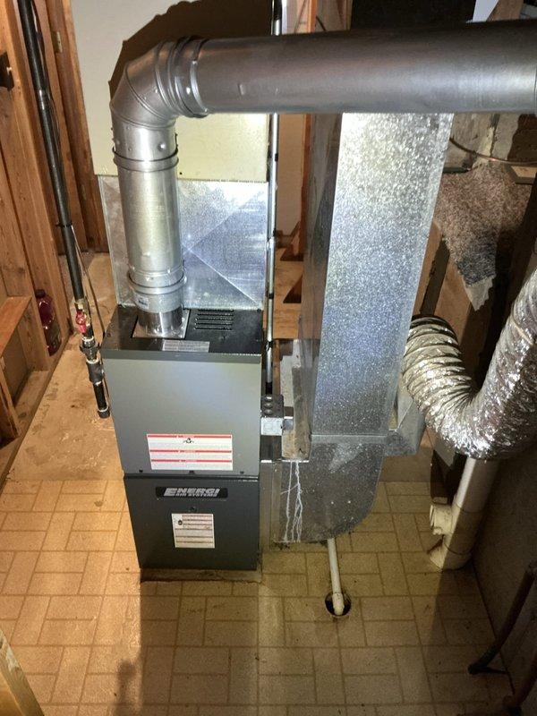 Performed air conditioning estimate on non-operational system in residential property with 18-year-old equipment. Documented existing HVAC installation including furnace unit with significant dust accumulation, ductwork configuration, and air handler components in basement utility area. System assessment completed to determine repair or replacement recommendations for customer consideration.