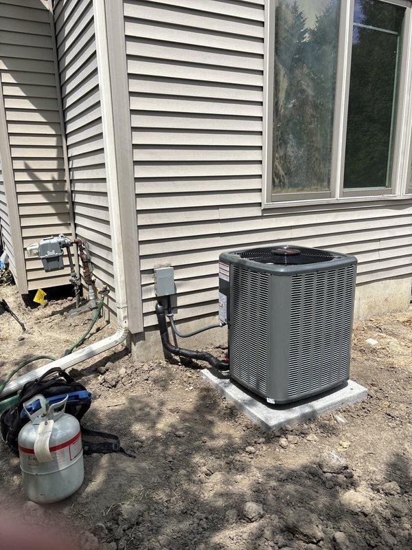 Completed full HVAC system installation including new furnace and air conditioning unit. Installed outdoor condenser unit on concrete pad with proper refrigerant line sets and electrical connections routed along exterior siding. Indoor furnace/air handler installed in basement utility area with new ductwork connections, PVC condensate drainage system, and proper venting. All equipment commissioned, tested for proper operation, and system left running efficiently.