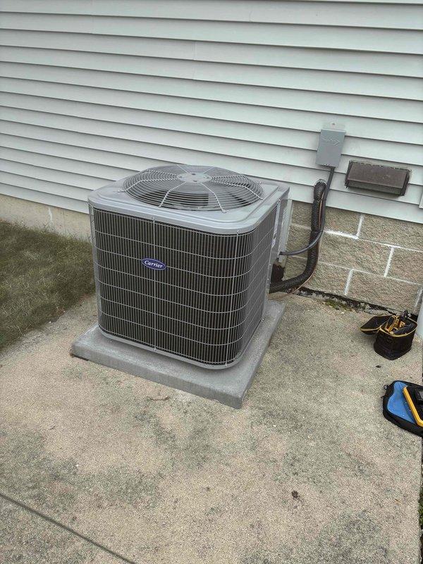 Completed full HVAC system installation including new furnace and air conditioning unit. Installed beige furnace unit in basement mechanical room on platform with proper ductwork connections and refrigerant line routing. Mounted Carrier brand outdoor condensing unit on concrete pad with electrical disconnect, refrigerant line set connection to house exterior, and proper clearances verified. All equipment secured, tested, and left in operational condition.