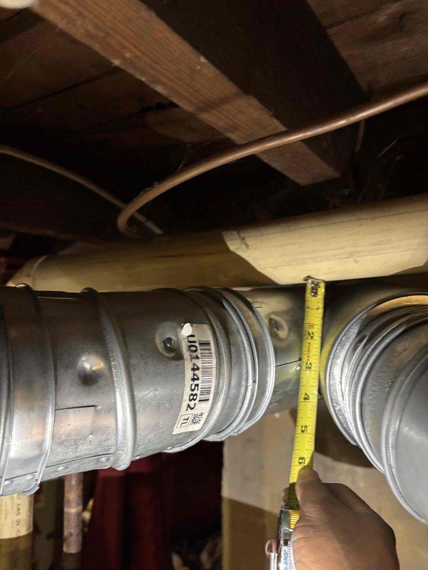 Corrected B-vent clearance violation by repositioning metallic vent pipe to achieve manufacturer-required minimum 1-inch clearance from combustible PVC pipe. Verified proper spacing with measurements and documented corrected installation to meet code compliance standards.