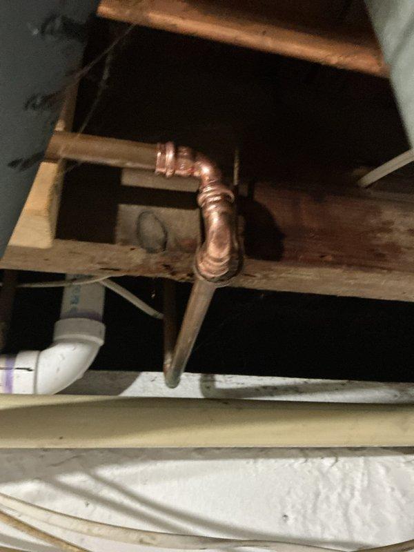 Responded to plumbing leak in basement of seventy-year-old residence. Upon inspection, identified leaking copper pipe joint in crawl space area that had been actively leaking for approximately one week. Assessed aged copper piping system showing oxidation and patina consistent with original home construction. Repaired defective pipe fitting, verified system integrity, and confirmed no additional leaks present in accessible plumbing. Documented conditions with photographs for customer records.