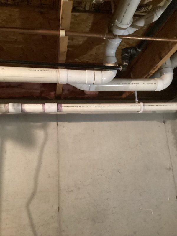 Completed inspector-requested corrections in basement mechanical area. Addressed small water leak at top of water heater and installed proper j-hook support for 2" PVC vent pipe to meet code requirements.