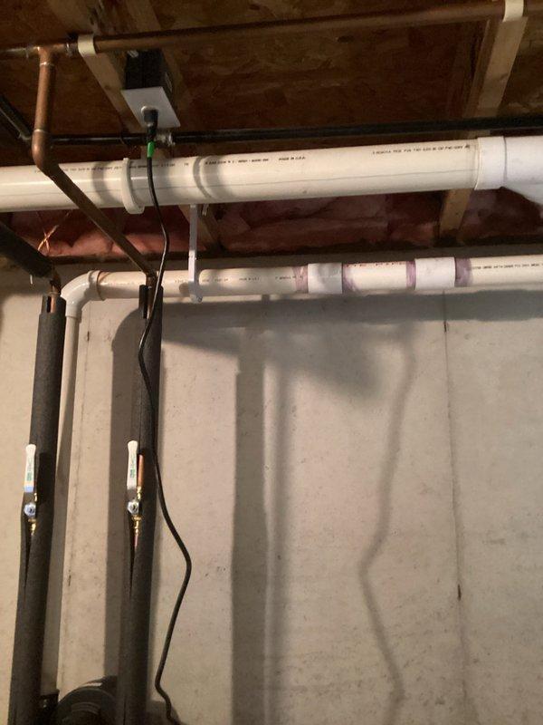 Completed inspector-requested corrections in basement mechanical area. Addressed small water leak at top of water heater and installed proper j-hook support for 2" PVC vent pipe to meet code requirements.