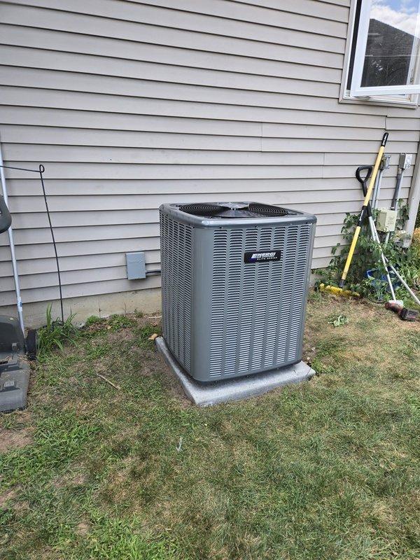 Completed full HVAC system installation including new furnace and air conditioning condenser unit. Installed outdoor AC unit on concrete pad at exterior corner location with proper clearances, secured refrigerant lines with mounting brackets along exterior wall, and ran electrical conduit to code. Connected and tested all refrigerant line sets, verified electrical connections, and ensured proper system operation. Unit positioned on level concrete foundation with adequate airflow access. All components installed per manufacturer specifications and industry standards. System startup completed successfully with all equipment functioning as designed.