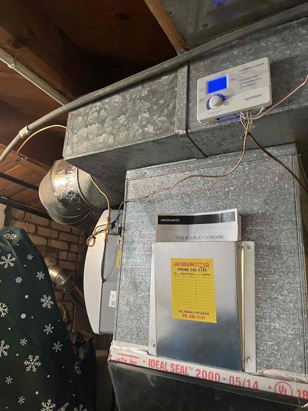 Completed installation of automatic whole-home humidifier system integrated with existing HVAC ductwork in attic space. Installed humidifier unit with digital control panel featuring blue display screen, connected all necessary wiring and ductwork transitions, and verified proper operation of system controls. All components secured and operational per manufacturer specifications.