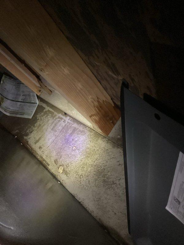 Responded to water leak concern originating from HVAC system in attic/crawl space area. Upon inspection, identified potential condensate drainage issue associated with air handler and humidification equipment. Examined 9-year-old Aprilaire humidifier, 9-year-old EnergiAir unit, and 11-year-old EnergiAir system, along with MicroPower Guard air filtration unit installed in basement. Verified heating and cooling operations remained functional throughout inspection. Documented existing equipment configuration, ductwork routing, and visible moisture indicators on concrete surfaces near HVAC components. Photographed installation layout including structural elements, ductwork connections, and filtration system for reference.