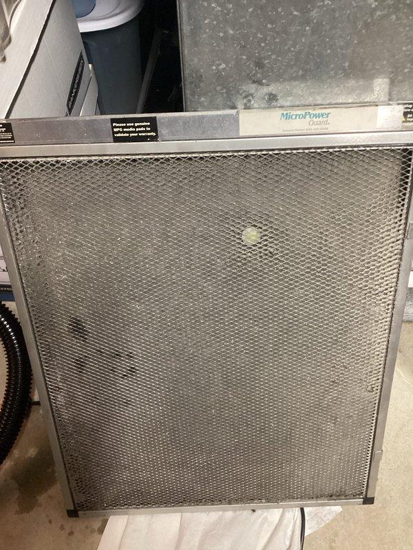 Responded to water leak concern originating from HVAC system in attic/crawl space area. Upon inspection, identified potential condensate drainage issue associated with air handler and humidification equipment. Examined 9-year-old Aprilaire humidifier, 9-year-old EnergiAir unit, and 11-year-old EnergiAir system, along with MicroPower Guard air filtration unit installed in basement. Verified heating and cooling operations remained functional throughout inspection. Documented existing equipment configuration, ductwork routing, and visible moisture indicators on concrete surfaces near HVAC components. Photographed installation layout including structural elements, ductwork connections, and filtration system for reference.