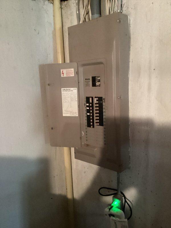 Conducted on-site evaluation for whole-house Generac generator installation at a residence built in 1985 with no existing backup power system. Assessed basement electrical infrastructure, including main service panel with circuit breakers and subpanel configuration, to determine optimal installation approach and required electrical upgrades. Documented existing 200-amp electrical service, panel capacity, and available space for generator transfer switch installation. Evaluated exterior placement options for generator unit considering gas line access, clearance requirements, and local code compliance. Photographed electrical panel layout, conduit routing, and basement utility area to support equipment sizing and installation planning. No safety concerns identified during assessment.