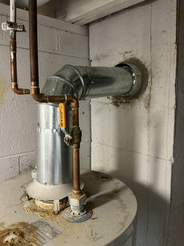 Responded to no-heat complaint on 15-year-old AO Smith water heater. Upon inspection, documented existing installation including copper supply lines, proper venting through exterior wall, and drain pan placement. Unit showed signs of age-related wear consistent with end of typical service life for residential water heaters.