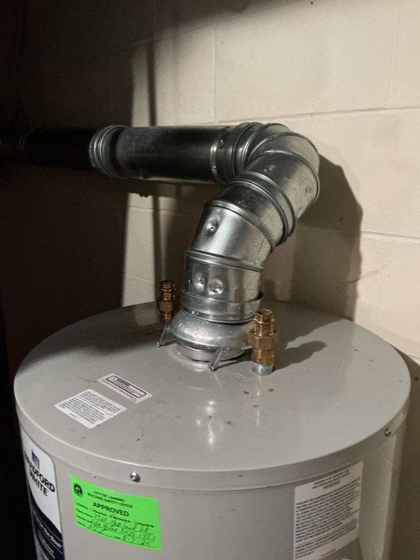 Responded to vandalized property with severed main water line and disconnected water heater. Assessed damage to plumbing infrastructure including cut water supply line and compromised water heater connections. Documented exposed plumbing assembly with valve mechanism showing corrosion and aging components, along with green pipe fittings and wall penetration. Inspected water heater with intact ventilation ductwork and brass fittings, though unit was disconnected from water supply. Photographed all affected areas for documentation purposes. Enrolled property in club membership program covering one furnace, one air conditioning unit, and one humidifier for ongoing maintenance services.