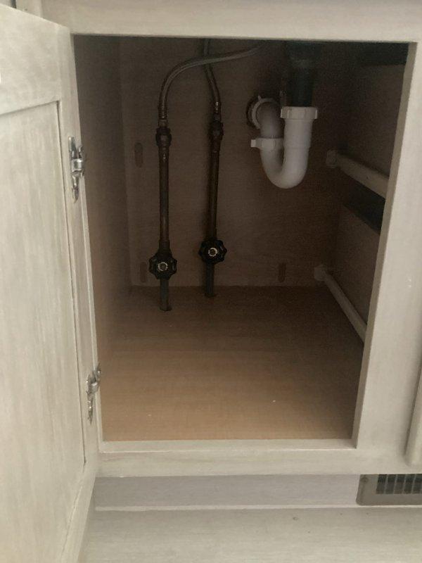 Responded to bathroom sink leak complaint and performed comprehensive plumbing inspection. Examined under-sink cabinet plumbing connections, including hot and cold water supply lines with shut-off valves and P-trap drain assembly. Inspected all visible plumbing components for signs of active leaks, loose connections, and proper installation. Tested water flow at bathroom vanity sink and monitored supply lines and drain connections during operation to identify source of reported leak. Checked all downstairs sinks for proper drainage function and flow rates. All plumbing connections found secure with no active leaks detected at time of inspection. Documented existing plumbing configuration with photos for service records.