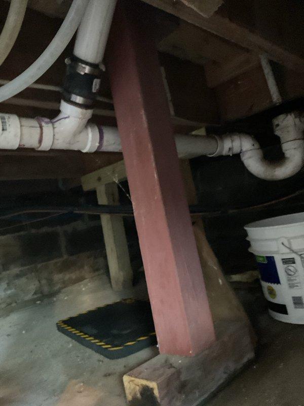 Responded to water leak reported underneath 21-year-old Comfortmaker furnace. Upon inspection, identified leak source in vicinity of heating system in basement area. Documented conditions with photographs showing plumbing infrastructure, support structures, and affected area beneath furnace location. System confirmed operational for both heating and cooling functions at time of visit. Placed containment materials including bucket and protective mat to manage water intrusion while assessment was conducted.