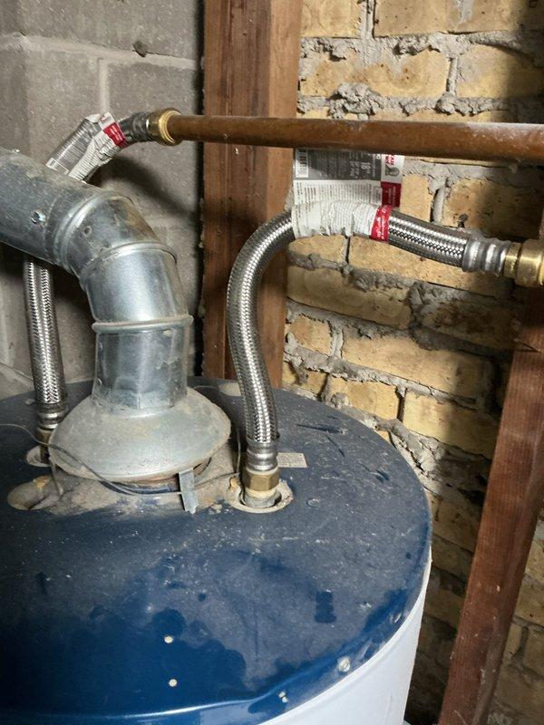 Responded to service call for 20-year-old Whirlpool natural gas water heater (model FG1F4040S3NOV) with pilot light failure. Diagnosed broken gasket in two pieces causing pilot to extinguish when reset button released. Provided estimate for complete replacement unit installation including proper permitting, removal and disposal of existing water heater, inspection and potential replacement of vent/flue system, brand and model recommendations with warranty details, and professional installation per code requirements for single-family residential application.