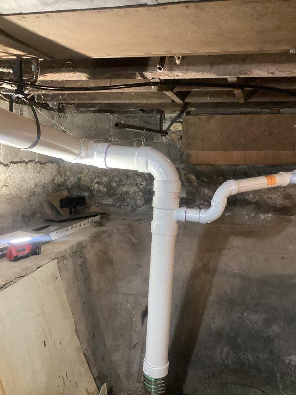 Completed waterline spot repairs in basement crawl space to eliminate all active leaks. Installed new white PVC drainage piping with multiple 90-degree elbows and fittings to create proper drainage configuration along concrete foundation walls. Secured all plumbing assemblies to floor joists with appropriate strapping and brackets to ensure code-compliant installation. All leak points were identified, removed, and replaced with new piping sections. System was pressure-tested and verified leak-free upon completion.