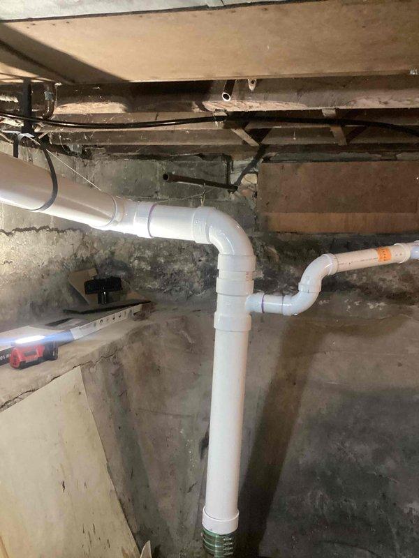 Completed waterline spot repairs in basement crawl space to eliminate all active leaks. Installed new white PVC drainage piping with multiple 90-degree elbows and fittings to create proper drainage configuration along concrete foundation walls. Secured all plumbing assemblies to floor joists with appropriate strapping and brackets to ensure code-compliant installation. All leak points were identified, removed, and replaced with new piping sections. System was pressure-tested and verified leak-free upon completion.