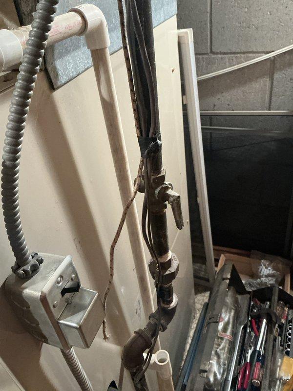 Conducted comprehensive assessment of existing furnace and air conditioning system for replacement estimate. Both units operational but showing age-related wear and reduced efficiency. Documented current installation including gas furnace with white PVC intake and exhaust venting, galvanized sheet metal supply plenum, and associated ductwork configuration in basement location. Photographed existing equipment layout, venting arrangement, electrical connections, and plumbing components to provide accurate proposal for new HVAC system installation.
