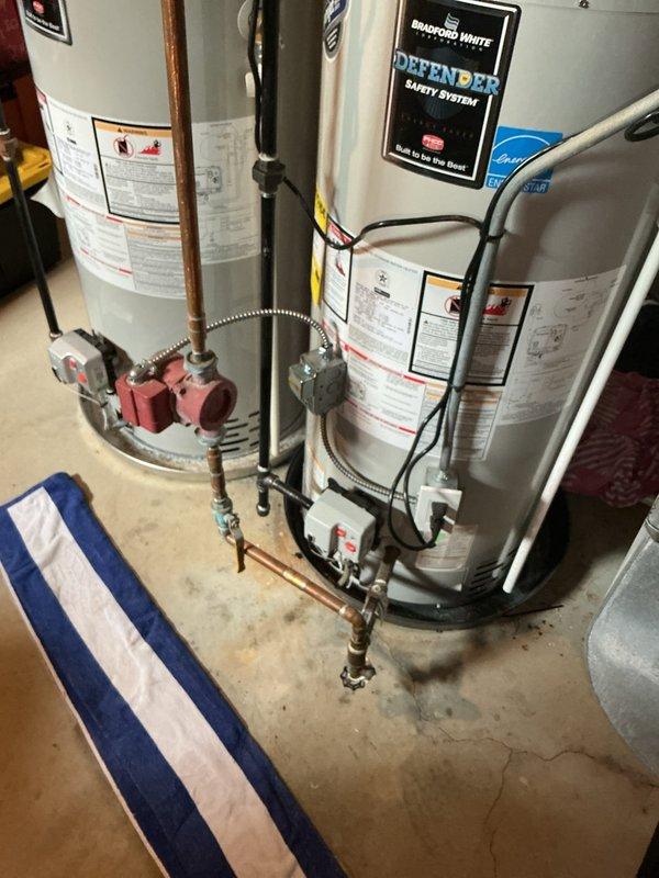 Responded to basement drain backup issue where bathroom drain was flowing upward. Assessed the drainage system and sump pump assembly, including the vertical PVC pipe configuration with shut-off valve and the floor drain opening. Cleared the clog in the basement drainage line, restoring proper flow direction and eliminating the backup condition.
