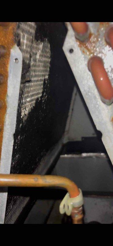 Completed quoted coil cleaning service on HVAC system. Accessed interior components and thoroughly cleaned evaporator coil assembly, which showed significant rust staining and moisture-related discoloration along the fin surfaces. Cleaned associated refrigerant lines, connections, and surrounding mechanical components to restore proper airflow and heat transfer efficiency.