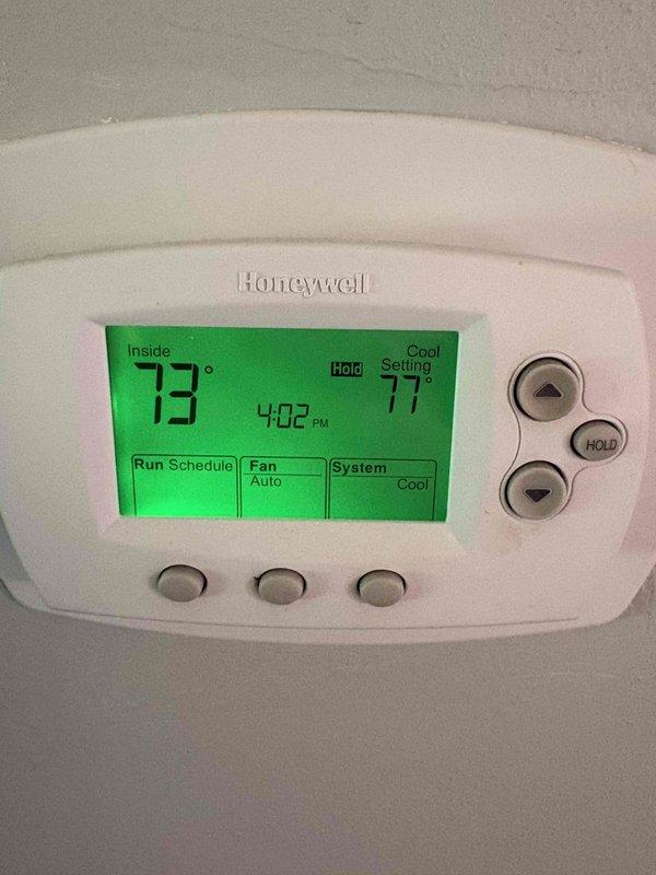 Responded to complaint of WD-40 like odor emanating from cold air return in living room area. Upon arrival, inspected 11-year-old furnace system and investigated odor source at multiple cold air return locations. Examined air filter for contamination and verified elevated odor concentration at upper living room return grille. Accessed furnace cabinet and inspected internal components including blower assembly, wiring connections, and condensate system for potential chemical odors or unusual substances. Photographed thermostat settings showing system operating in cooling mode and documented internal furnace components during inspection. No immediate mechanical failures or safety hazards identified during visual inspection of motor assembly, electrical connections, and piping systems.