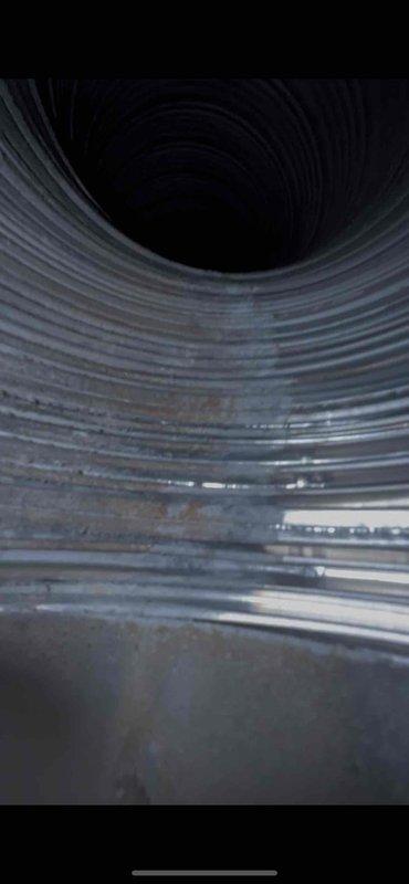 Responded to inspector correction request regarding chimney liner verification. Accessed and photographed the interior of the metal vent pipe, documenting the presence of corrugated flexible liner extending upward through the chimney chase. Captured clear images showing the spiral-ribbed B-vent construction and forwarded documentation to the administrative contact as requested to satisfy inspection requirements.