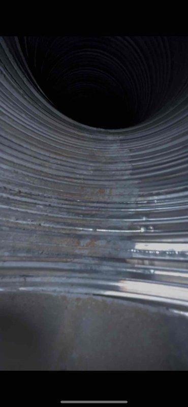 Responded to inspector correction request regarding chimney liner verification. Accessed and photographed the interior of the metal vent pipe, documenting the presence of corrugated flexible liner extending upward through the chimney chase. Captured clear images showing the spiral-ribbed B-vent construction and forwarded documentation to the administrative contact as requested to satisfy inspection requirements.