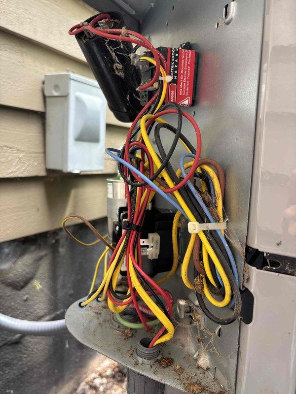 Responded to service call for 13-year-old Carrier system with motor humming when unit was off. Upon inspection, identified faulty contactor causing the humming issue due to stuck contacts maintaining partial circuit engagement even in the off position. Accessed exterior electrical control panel and inspected internal wiring and components. Found 46.5 UF hermetic capacitor and associated electrical connections in serviceable condition. Addressed contactor malfunction by inspecting relay contacts and wiring connections, ensuring proper system shutdown when thermostat calls are not active. Verified all wire terminations were secure and properly routed. Tested system operation to confirm motor no longer hums during off cycle and unit responds correctly to thermostat commands. System restored to normal operating condition with proper on/off functionality.