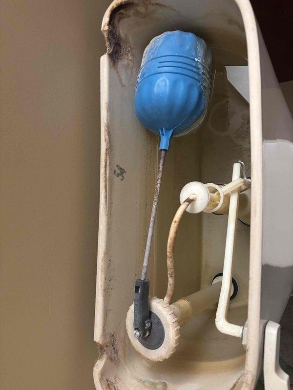 Responded to follow-up service call for ongoing toilet leak. Removed tank lid and inspected internal flush mechanism components. Found deteriorated flapper valve and excessive mineral buildup throughout tank interior causing improper seal. Replaced faulty flapper, cleaned flush valve seat, and tested fill valve operation to ensure proper water shutoff and eliminate persistent leak.