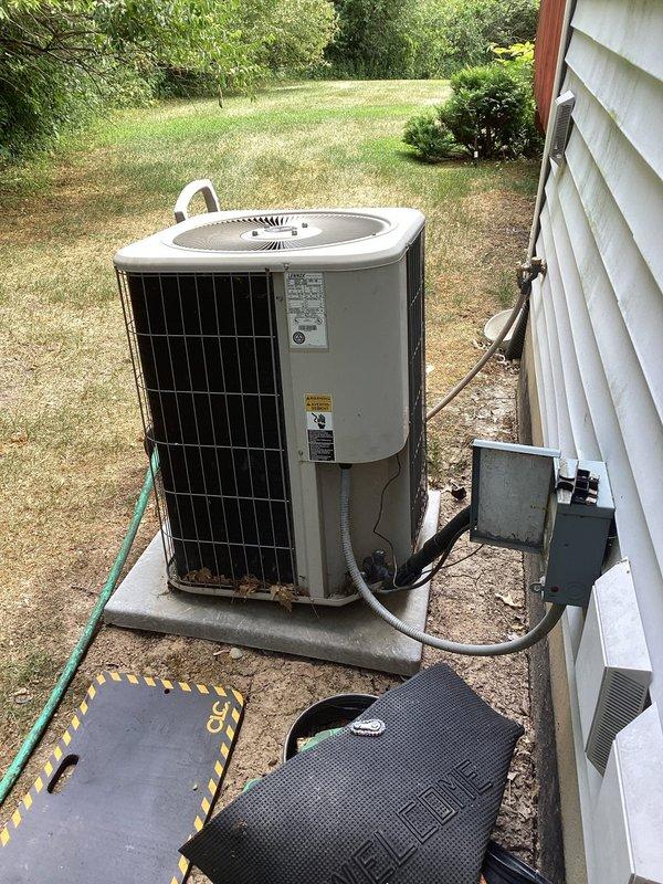 Completed annual cooling maintenance on a 2016 Lennox air conditioning system. Performed comprehensive tune-up including inspection of outdoor condenser unit, verified refrigerant line connections, checked electrical disconnect box and conduit, and assessed overall system operation. Unit showed minor rust staining at base but remains in serviceable condition with all components functioning properly.