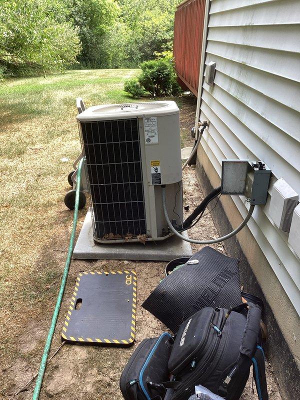 Completed annual cooling maintenance on a 2016 Lennox air conditioning system. Performed comprehensive tune-up including inspection of outdoor condenser unit, verified refrigerant line connections, checked electrical disconnect box and conduit, and assessed overall system operation. Unit showed minor rust staining at base but remains in serviceable condition with all components functioning properly.