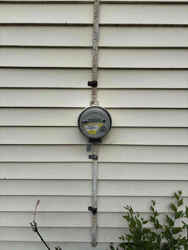 Completed electrical estimate for residential property with 2019 construction. Inspected main electrical panel located in storage/utility area and exterior electric utility meter with associated conduit and mounting hardware. Documented existing electrical infrastructure including meter base, service conduit, and panel accessibility for future work planning.