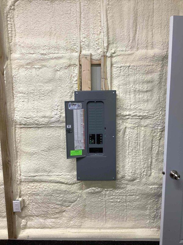 Completed estimate for central air conditioning system and ductless mini-split installation in barn structure. Documented existing electrical infrastructure including main breaker panel with available capacity and spray foam insulated walls to assess equipment placement and installation requirements for proposed HVAC systems.