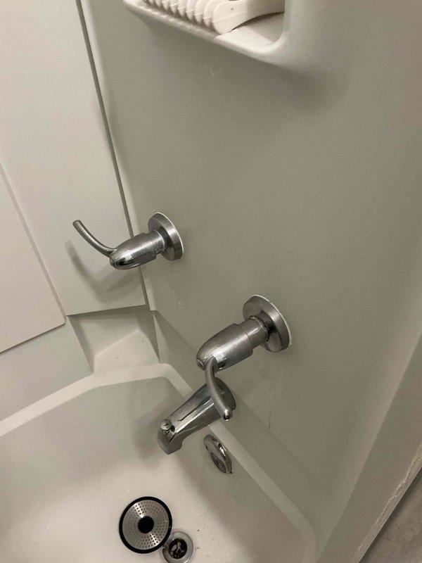 Responded to plumbing leak concern with water surfacing in basement, suspected to be related to previous tree root intrusion in main sewer line. Installed decorative escutcheons on bathroom fixtures including bathtub spout, shower diverter valve, and temperature control handles to provide finished appearance and proper wall sealing. All fixtures photographed and verified for proper installation and functionality.