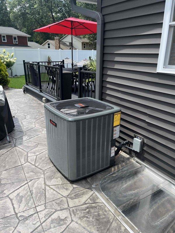 Completed full air conditioning system replacement including outdoor condenser unit and indoor air handler components. Installed new Lennox furnace with integrated HVAC system, configured all ductwork connections, exhaust venting with metal banding, PVC condensate drainage lines, and electrical wiring. New outdoor condenser unit positioned on existing patio surface against residential siding with proper clearances maintained for airflow and serviceability.