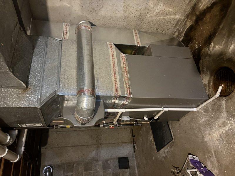 Responded to no-cool condition on 20-year-old central air conditioning system serving single-family residence. Upon arrival, confirmed outdoor condenser unit was attempting to start but failing to run, producing noise during start-up attempts with no cooling output. Performed diagnostic assessment of both indoor air handler and outdoor condensing unit, documented equipment age and condition through photographic documentation, and identified system failure preventing compressor operation. Due to advanced age of equipment and nature of mechanical failure, provided customer with repair versus replacement options and recommendations for restoring cooling capacity to the home.