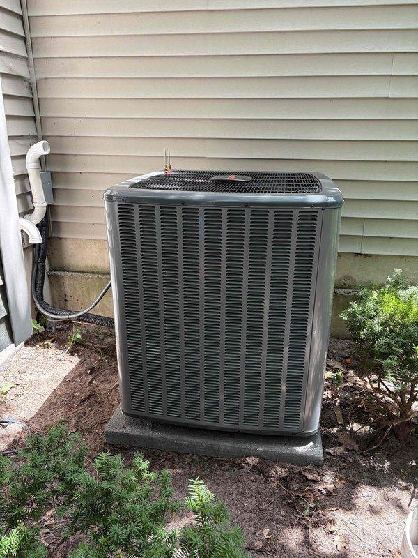 Completed full HVAC system installation including new furnace and air conditioning condenser unit. Installed furnace in basement utility area with proper clearances for maintenance access. Connected refrigerant lines, ductwork, and ventilation components. Mounted outdoor AC condenser unit on composite pad against exterior wall with proper clearance. Installed condensate drain line with white PVC piping along exterior wall. Verified all electrical connections, refrigerant line connections, and duct sealing. Installed new air filter in system. System tested and operational upon completion.