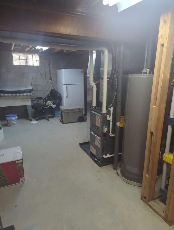 Completed full HVAC system installation including new furnace and air conditioning condenser unit. Furnace installed in basement utility area with proper PVC venting and connection to existing ductwork. AC condenser positioned on exterior concrete pad against building with appropriate clearance, connected refrigerant lines, and verified proper refrigerant charge using manifold gauges. All electrical connections completed, system tested and operational.