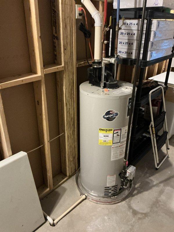 Conducted on-site evaluation for furnace and water heater replacement in a 2013-built residential property with original equipment. Assessed existing HVAC system including air handler with foil-wrapped ductwork, water filtration system with multiple cylindrical filter cartridges, and associated refrigerant lines. Evaluated white cylindrical water heater with PVC venting, copper supply connections, and pressure relief valve assembly. Documented mechanical room configuration including exposed framing, drainage systems, and utility connections. Photographed all equipment specifications, manufacturer labels, and installation components to provide accurate replacement recommendations for both units reaching end of serviceable life.