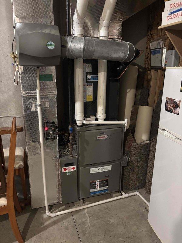Completed full air conditioning system replacement in residential basement utility area. Installed new Lennox HVAC unit with integrated furnace system, including proper mounting, electrical connections, and refrigerant line installation. Connected and secured all PVC condensate drainage lines and metal ductwork to existing ventilation infrastructure. Performed system startup, charged refrigerant to manufacturer specifications using manifold gauges, and verified proper pressures and temperatures across all zones. All components tested and operational upon completion.
